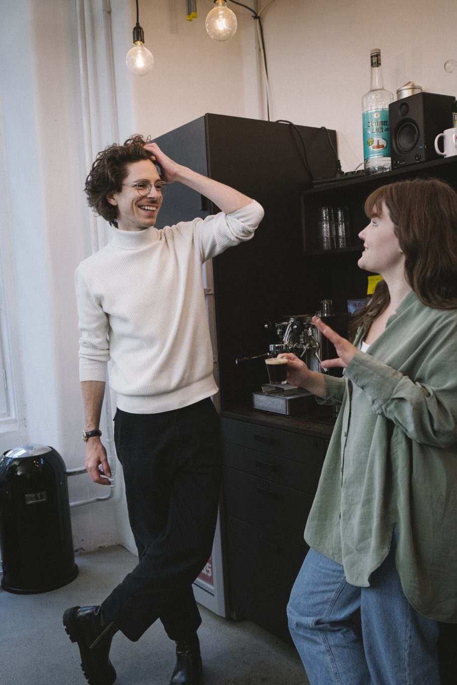 Man and woman talking in a kitchen with coffee 